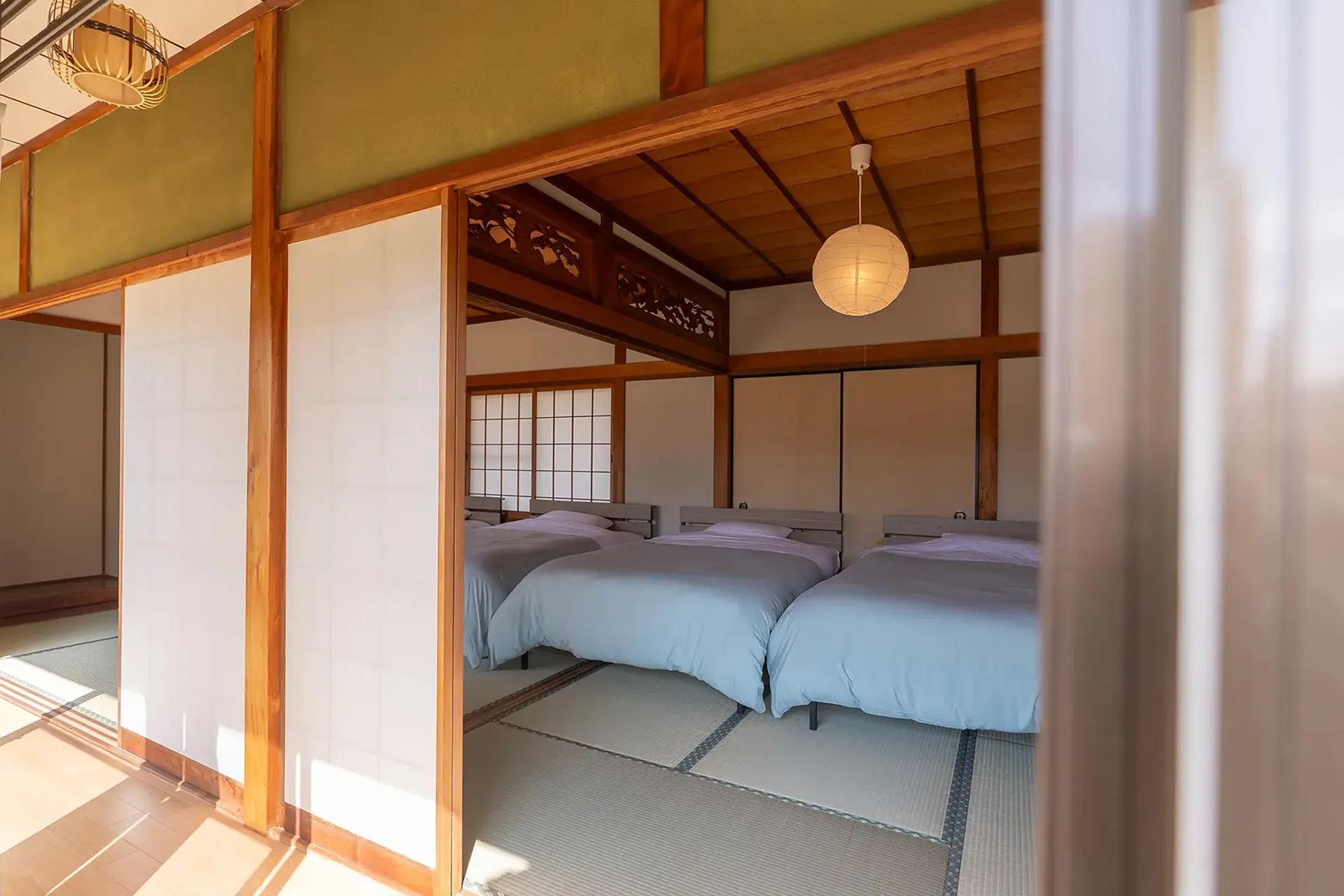 Tatami bedroom with three beds at The M Naegi