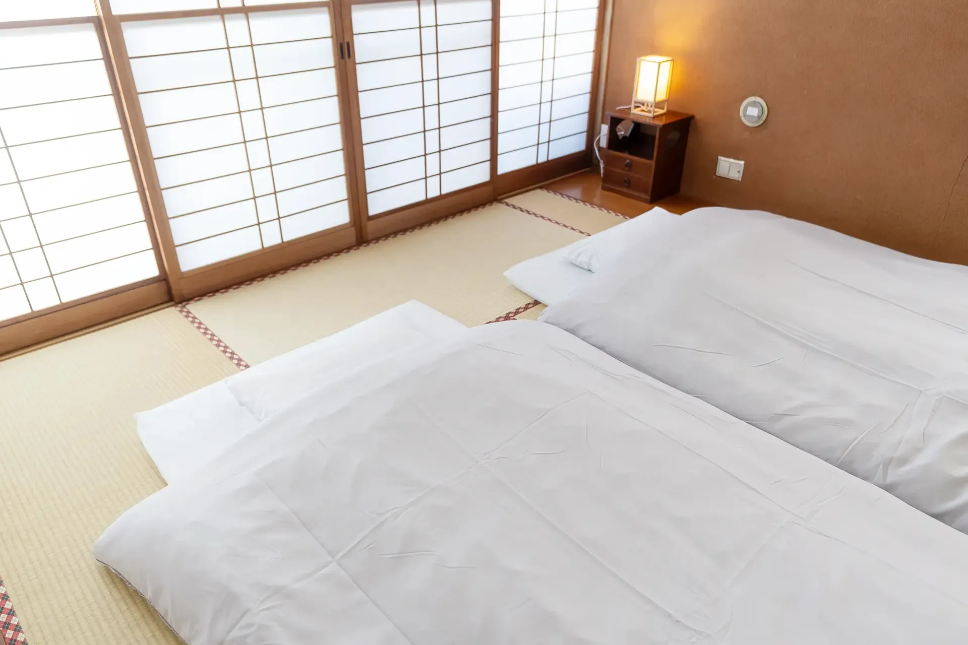 Tatami room with futon bedding at The M Otamachi